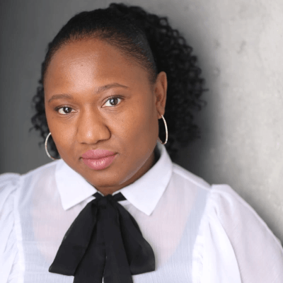 A woman with a white and black shirt smiling