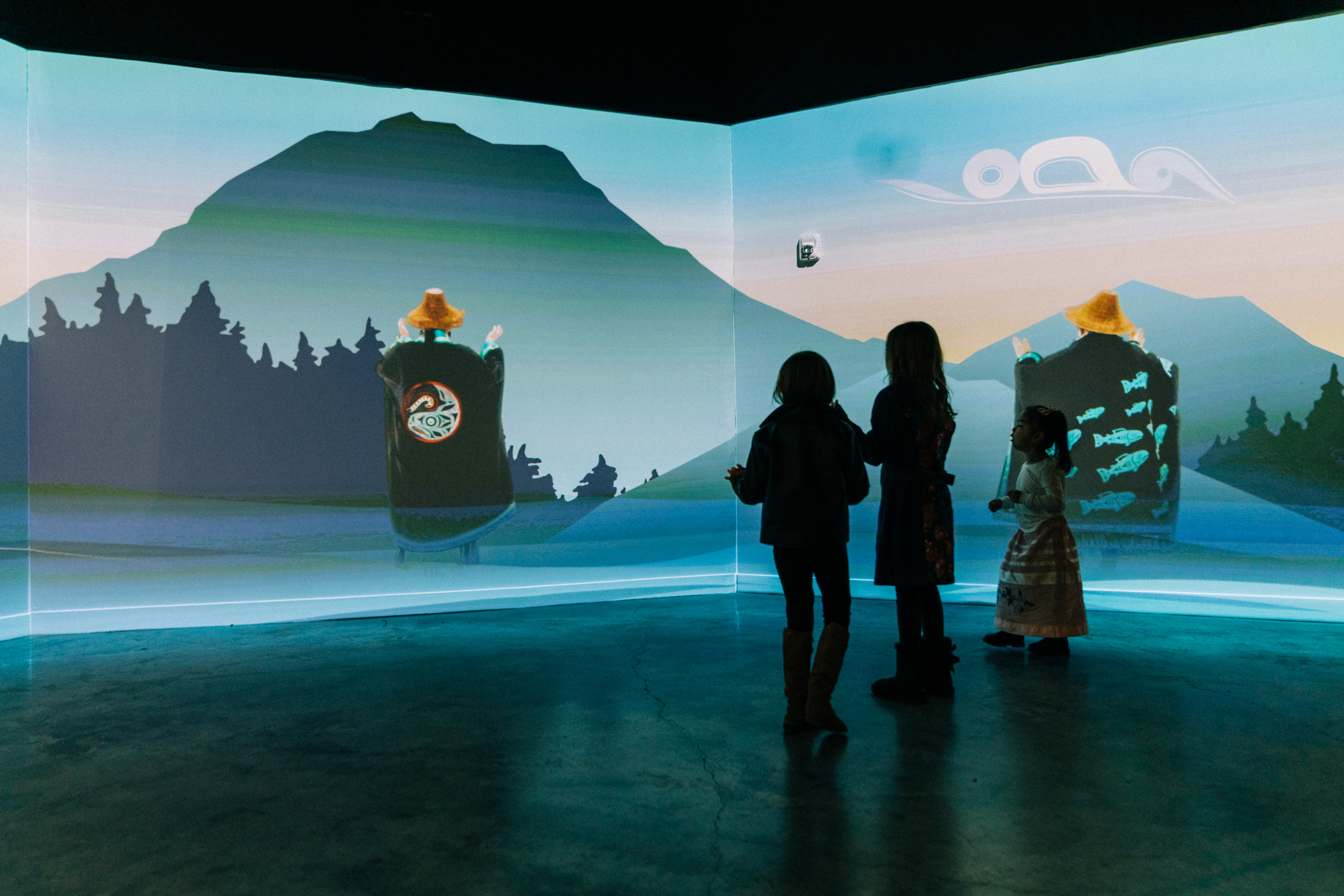 3 kids standing in front of Matika Wilbur art installation